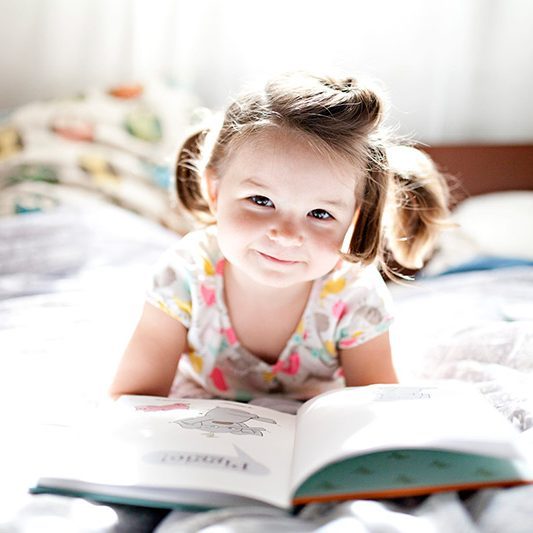 CHILDHEADERpreschool-girl-lies-on-a-bed-in-soft-window-light-reading-books_t20_yv4YOp-1-scaled-1-circle-50d07b5ef38be9a23b00f5867d6f340d-bd41mspxhwne